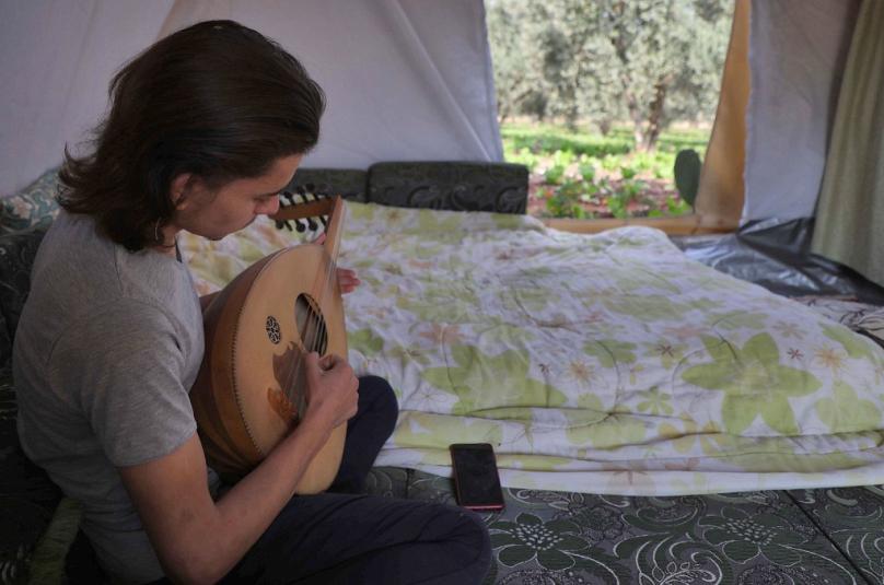 شاهد: بسبب الحرب وبعد النزوح... شاب سوري نسخ منزل طفولته بالكتب والنباتات في خيمة